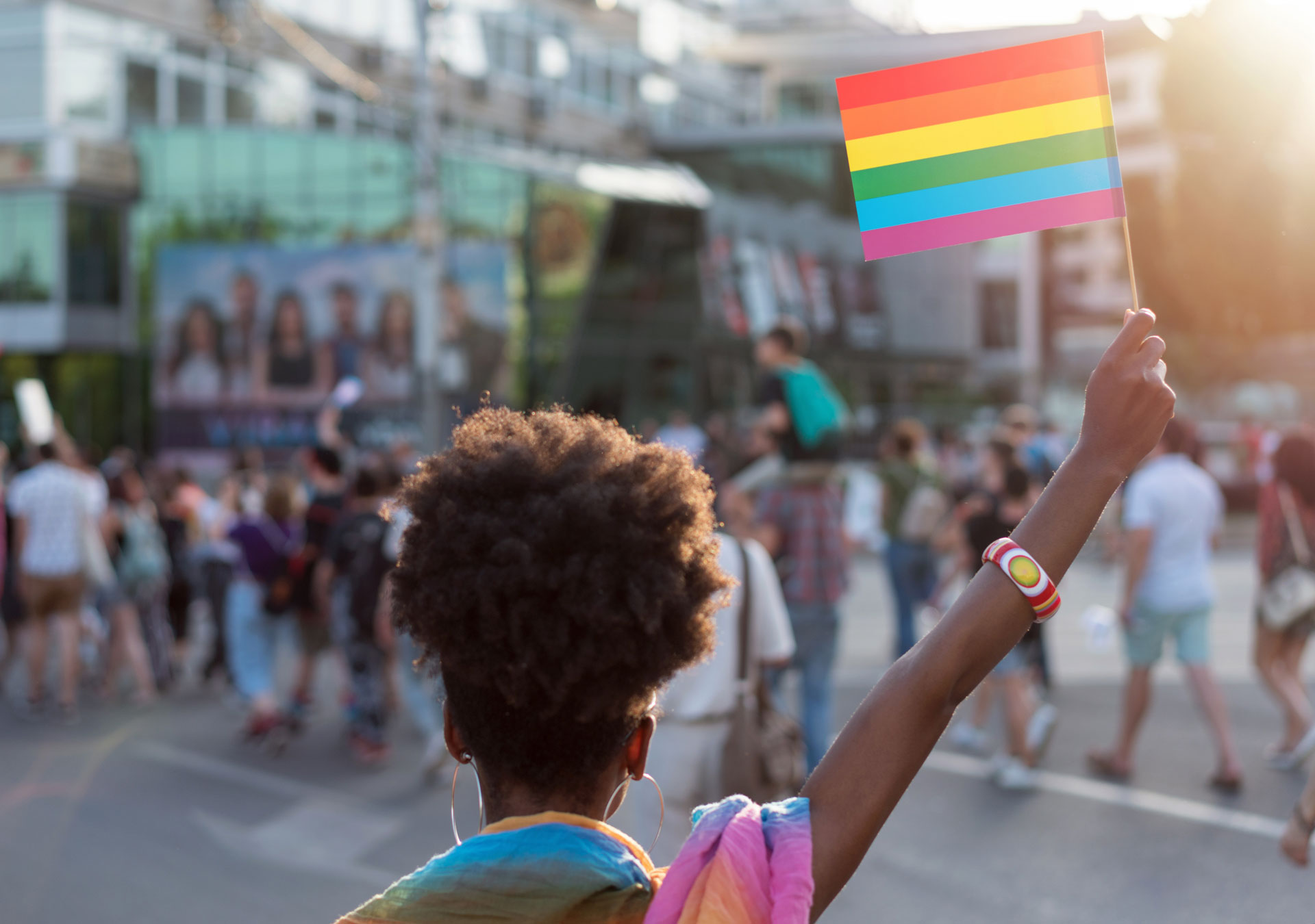 Person holding a rainbow flag